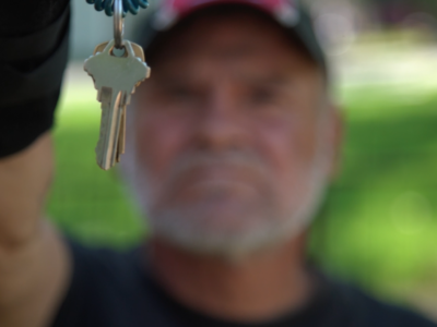 Man holding up new set of keys