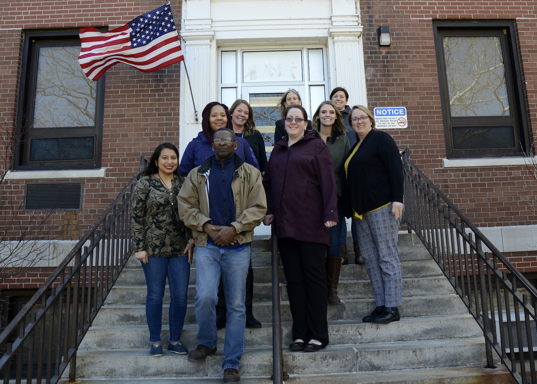 Smiling team members at city building