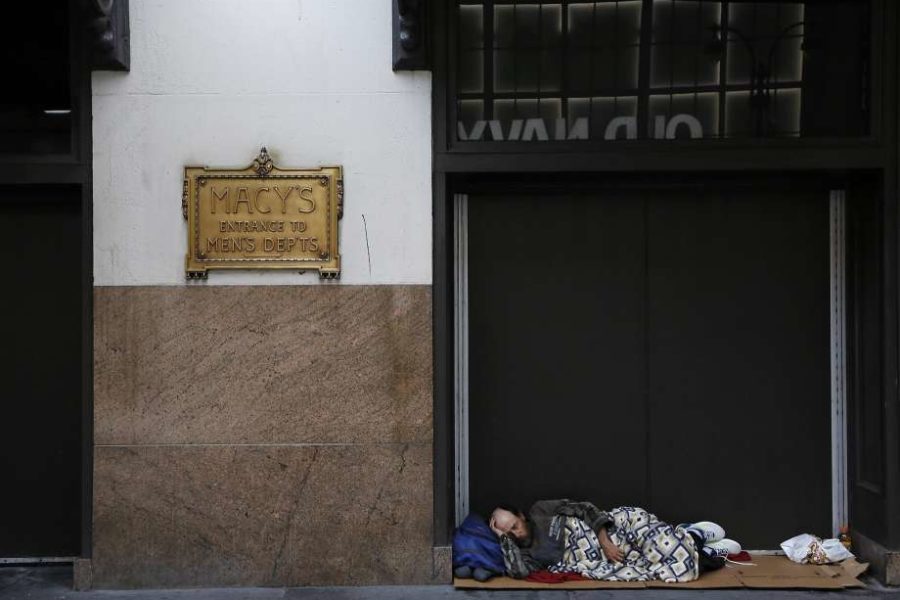 Homeless man sleeping outside of Macy's