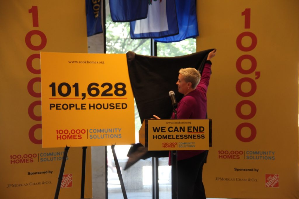 Woman standing by signage