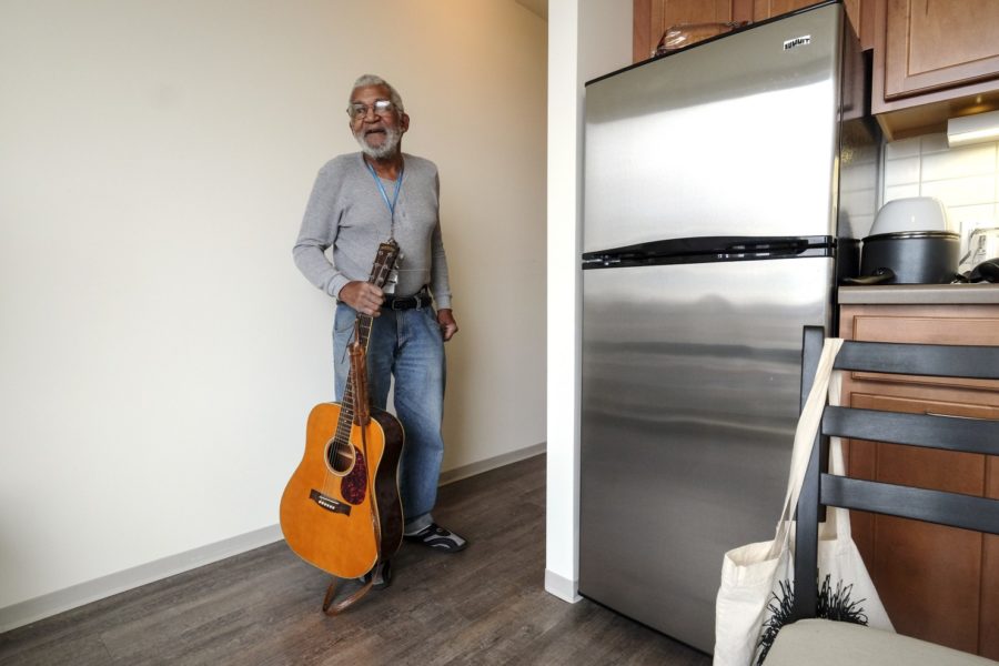 Newly-housed former homeless man in new apartment