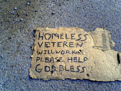 Homeless Veteran's signage reading "Will Work, Please Help."