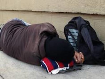 Homeless man asleep outside