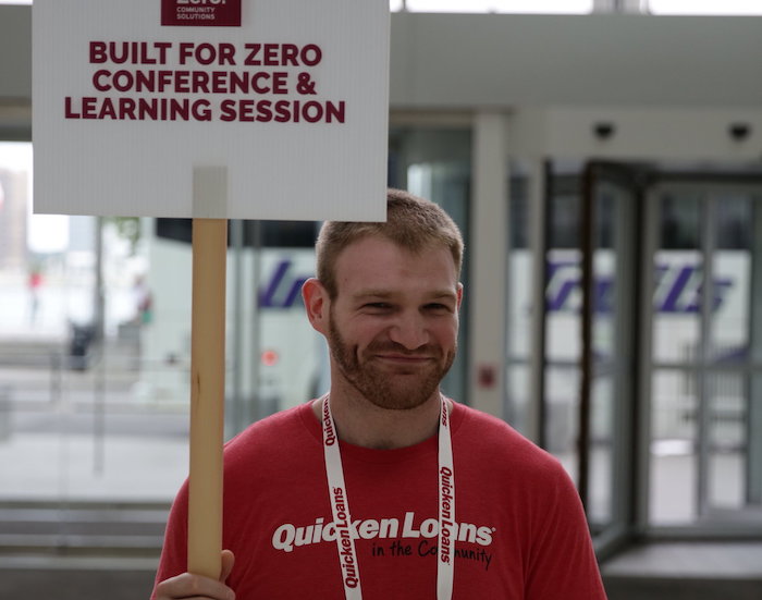 man holding conference sign