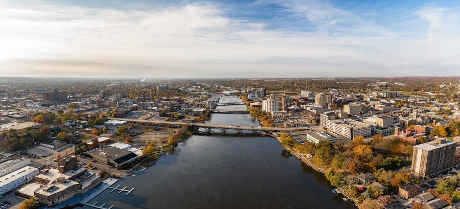 The community of Rockford stretches along two sides of a river linked by flat bridges.