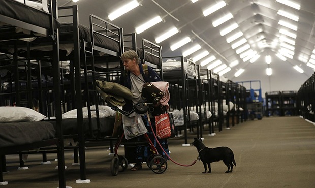 Woman and dog in homeless shelter (AP Photo/Gregory Bull)