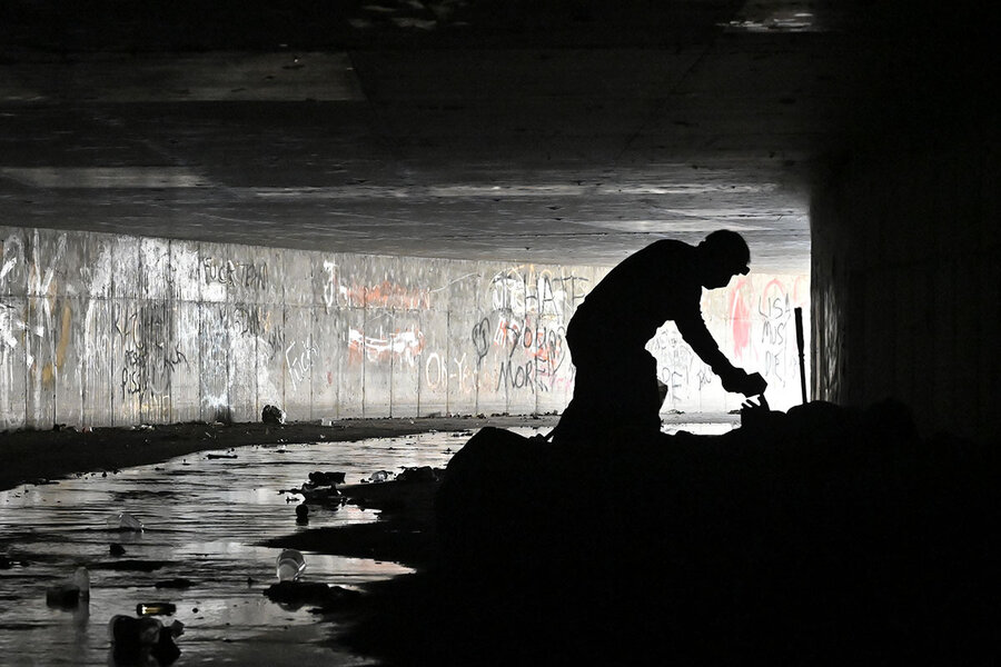 David Becker AP - Dave Marlon of CrossRoads of Southern Nevada offers items to a person living in a tunnel in Las Vegas.