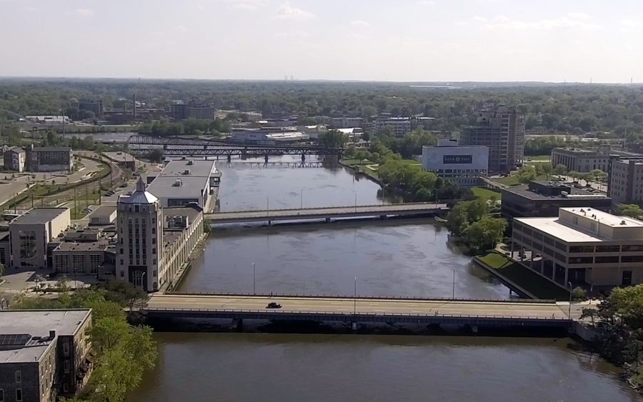 Rockford, IL spreads out across two separate banks of a river, intersected by two low bridges.