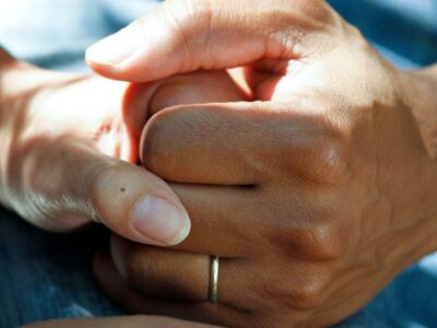 Hands clasped together, credit: American City and County Magazine