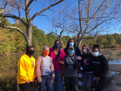 Team photo outside wearing masks