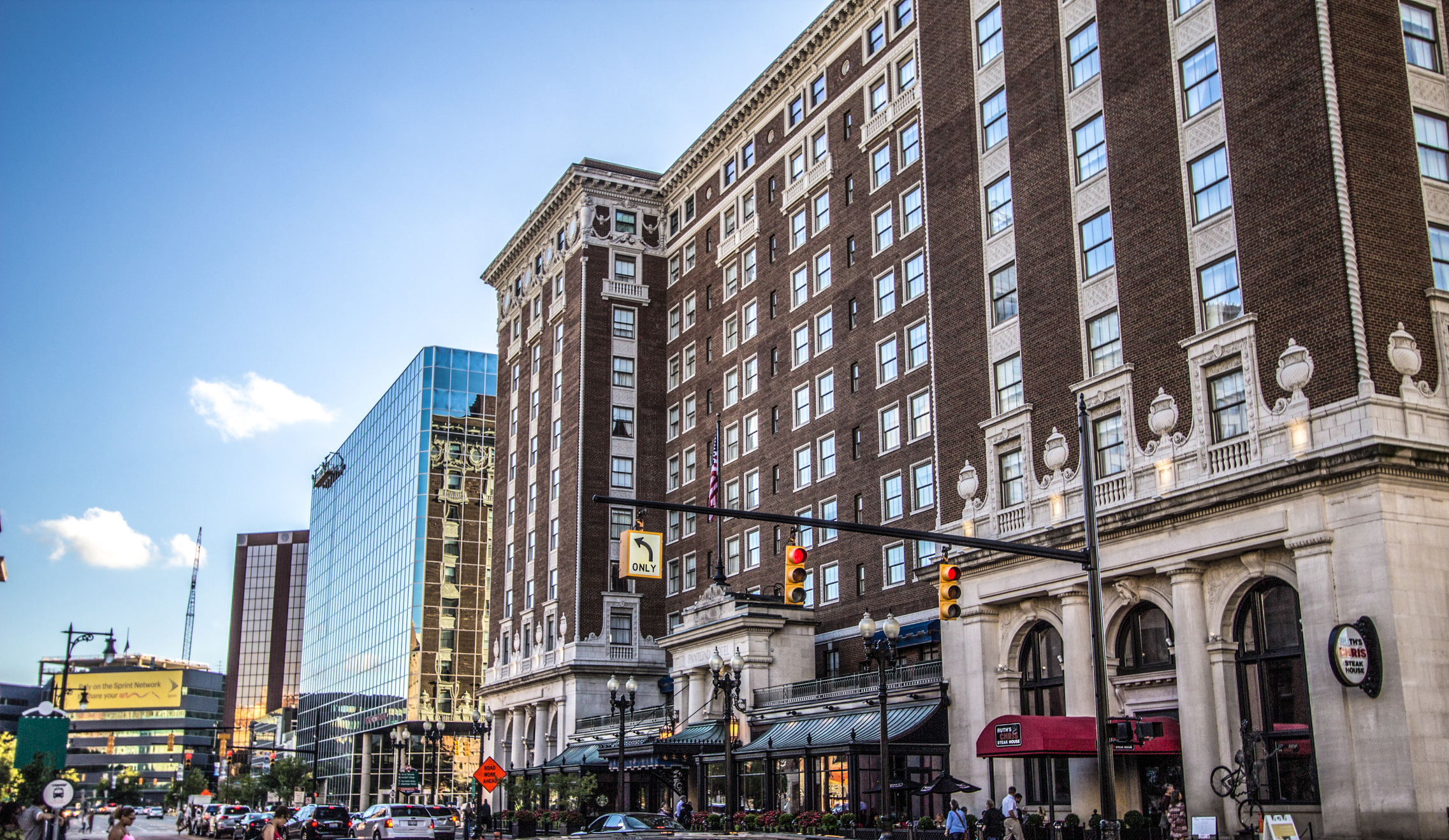 Large hotel building in downtown Grand Rapids with streetlights and cars