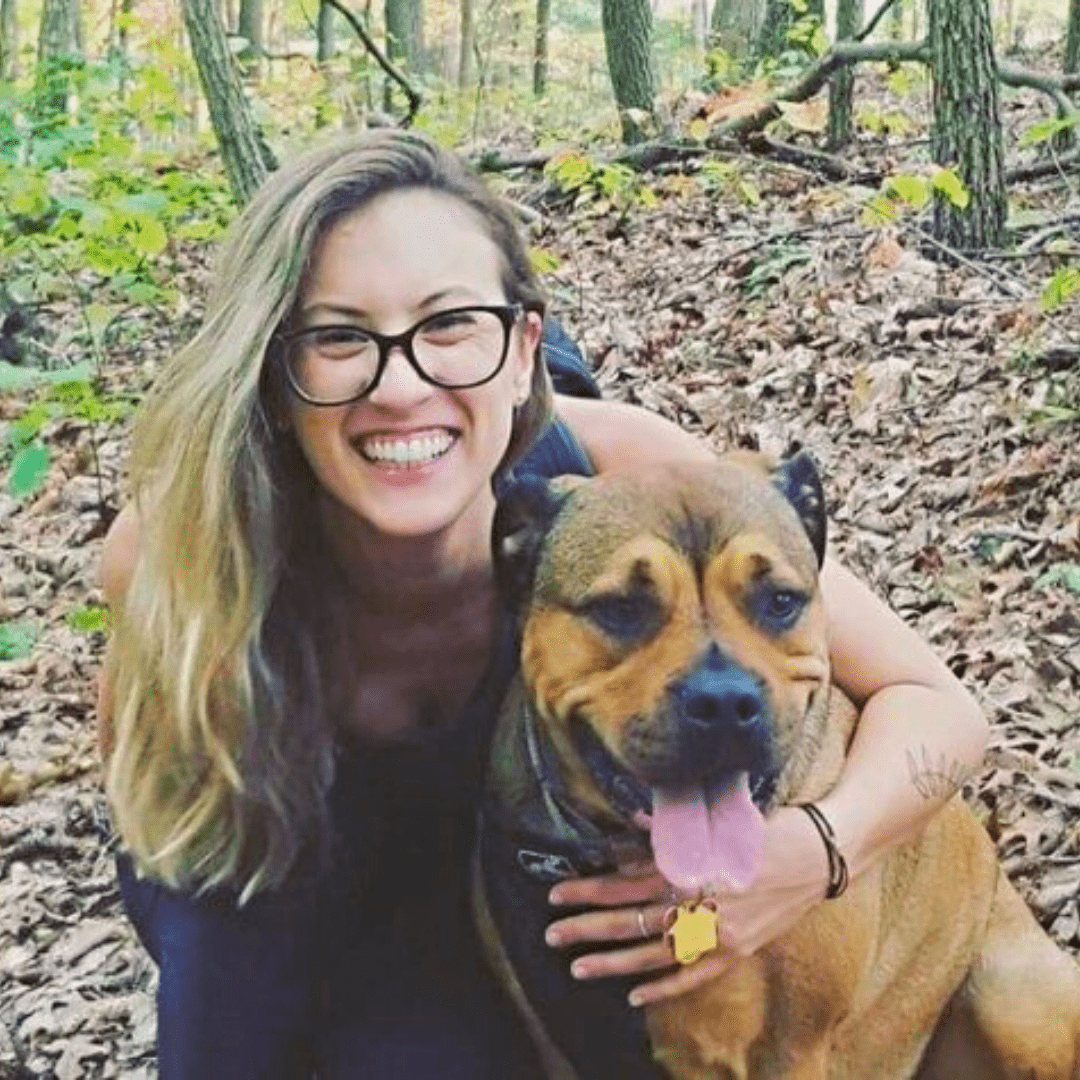 Woman smiling next to dog