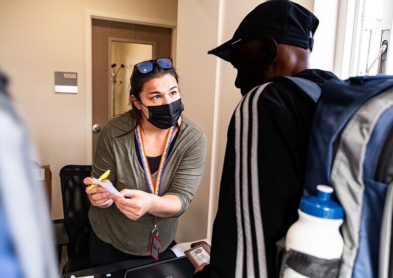 Lauren Lapinski, Coordinated Entry Specialist at the VA Eastern Colorado Health Care System checks in participants at the 2023 Annual Homelss Veterans Stand Down event at the VA Community Resource and Referral Center in Denver, Colorado.